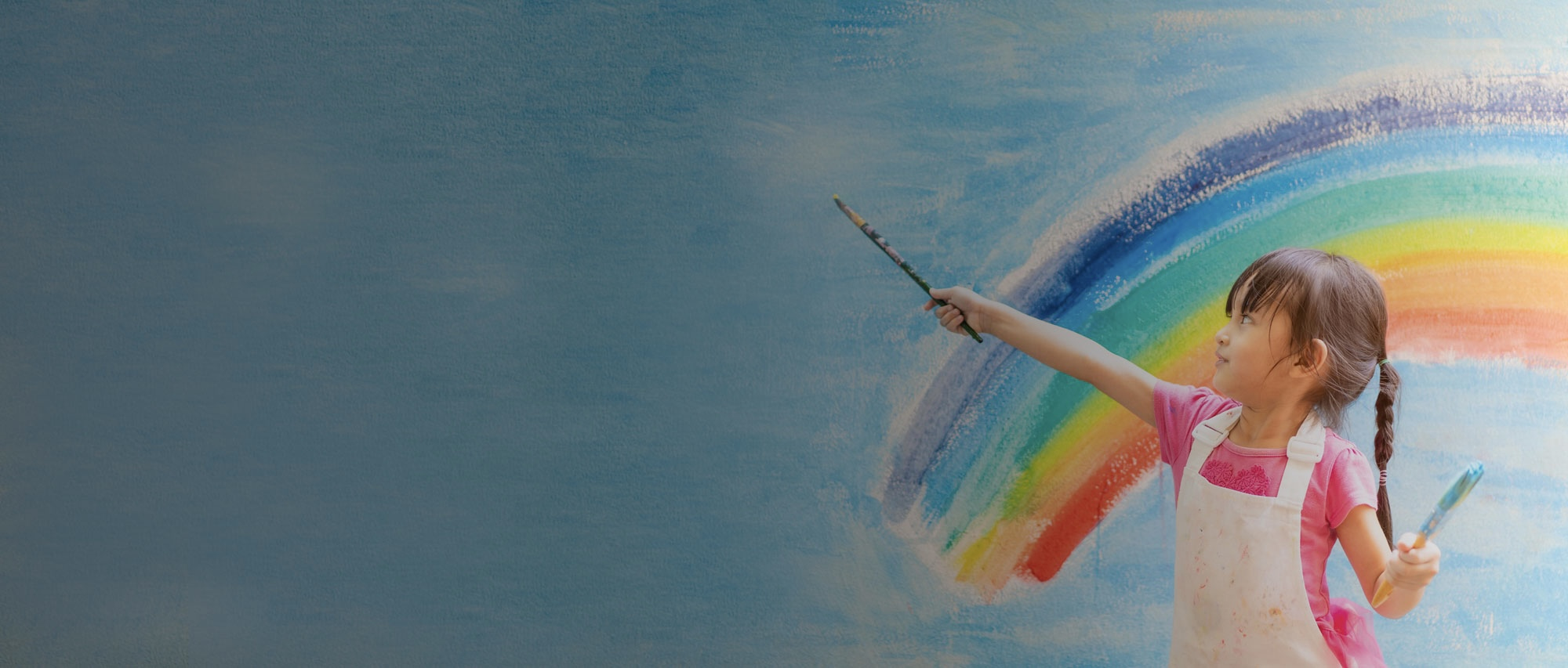 A girl painting a rainbow